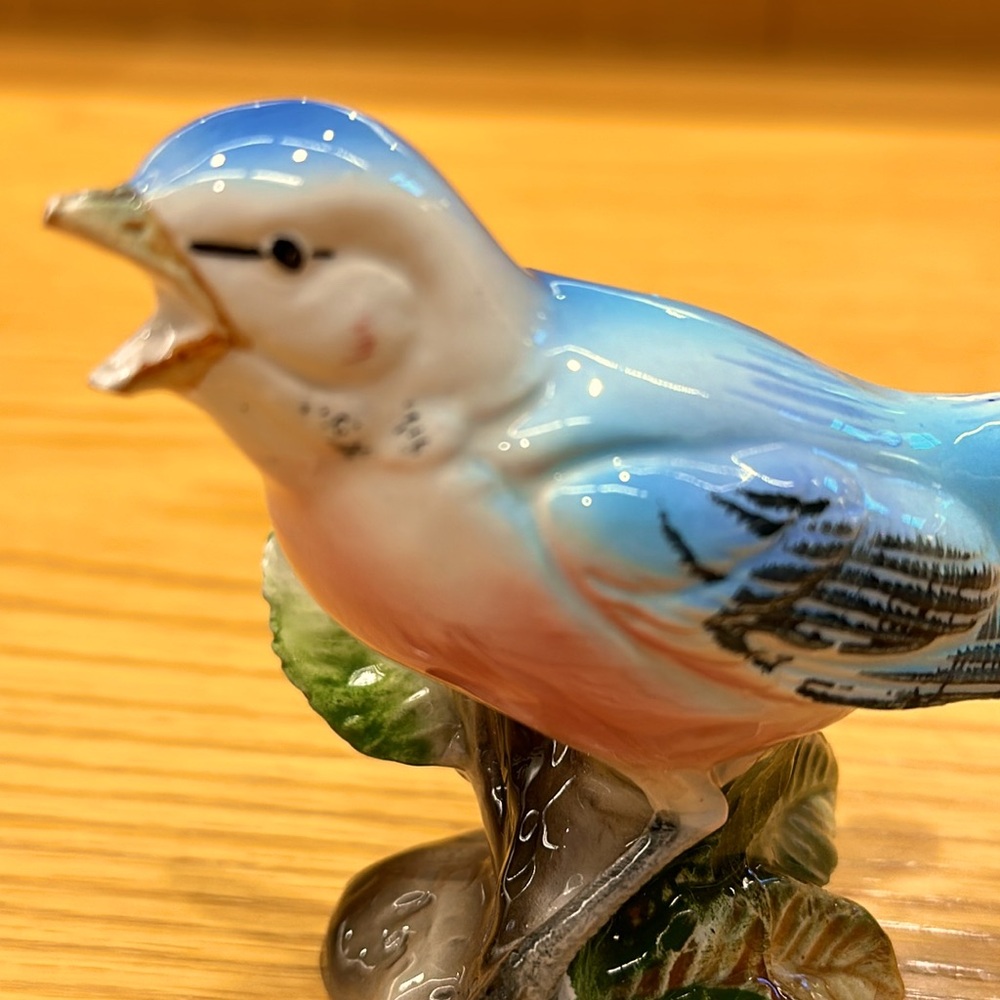 Blue bird statue with open mouth